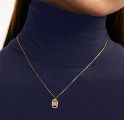 A diamond M necklace featuring a sparkling letter “M” pendant adorned with diamonds on a delicate chain, adding a luxurious and personalized touch.